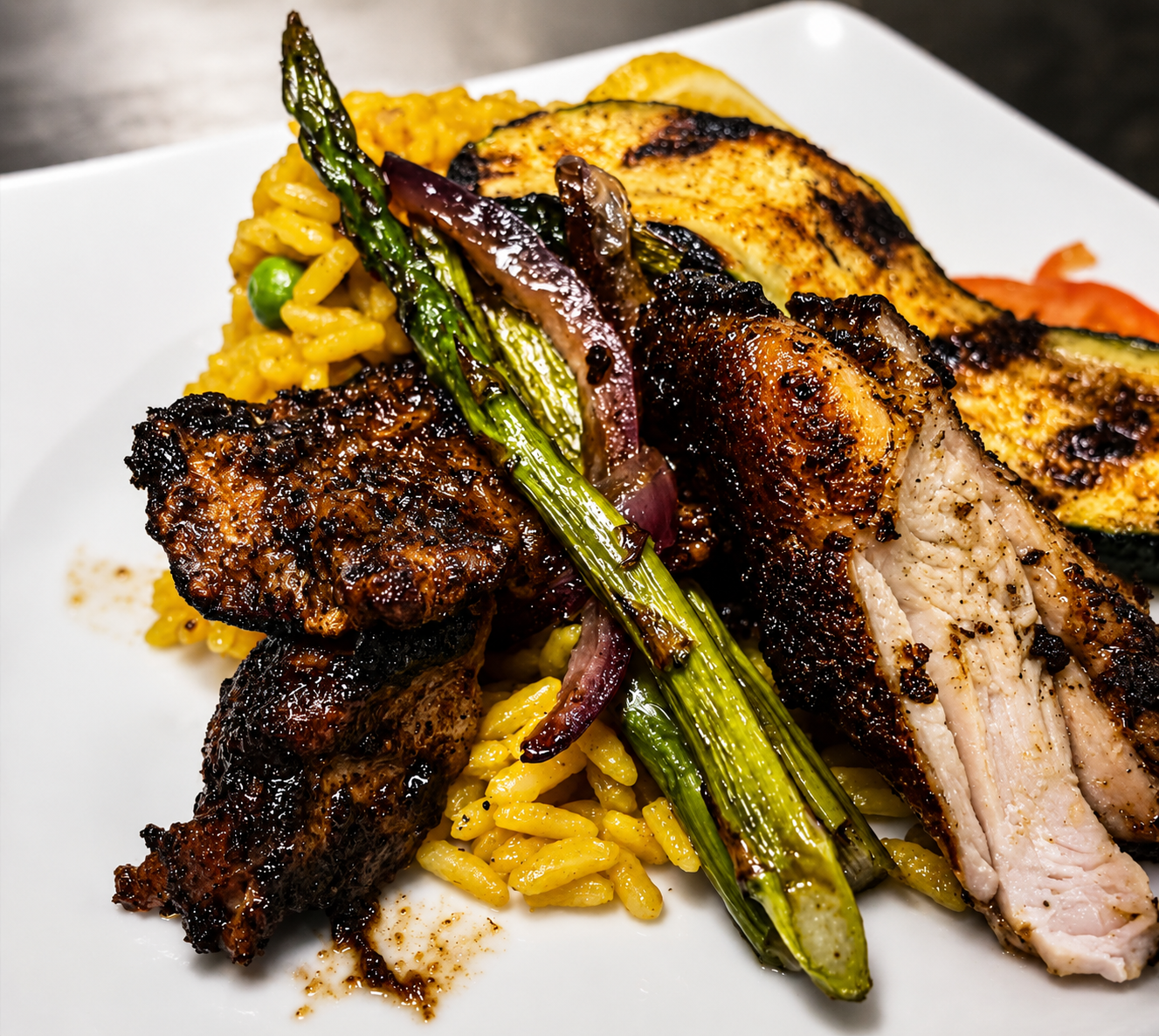 Blackened chicken with saffron rice, grilled asparagus and zucchini at The Block Bistro & Grill
