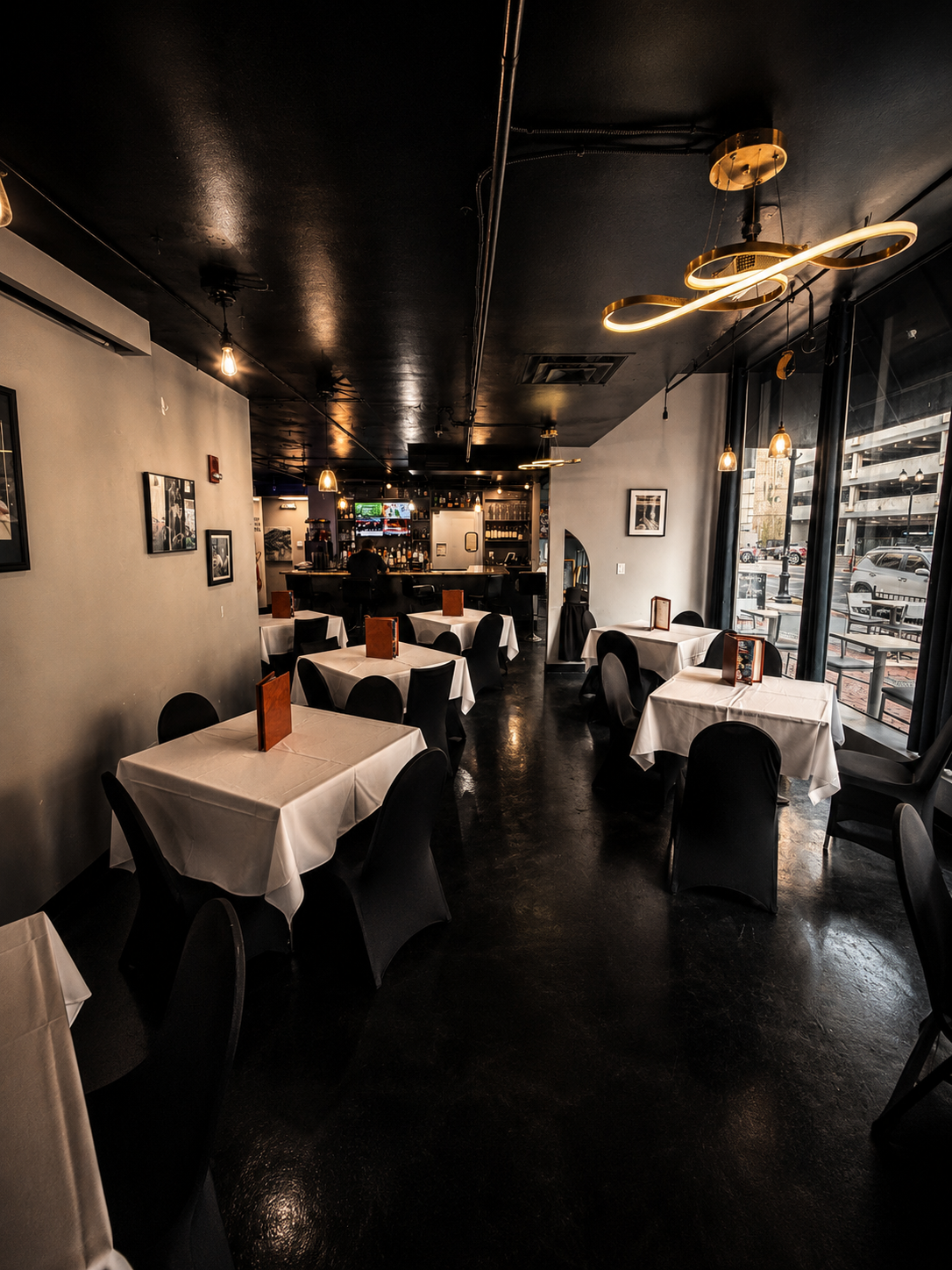 The Block Bistro & Grill dining room with white linen tables and warm golden lighting
